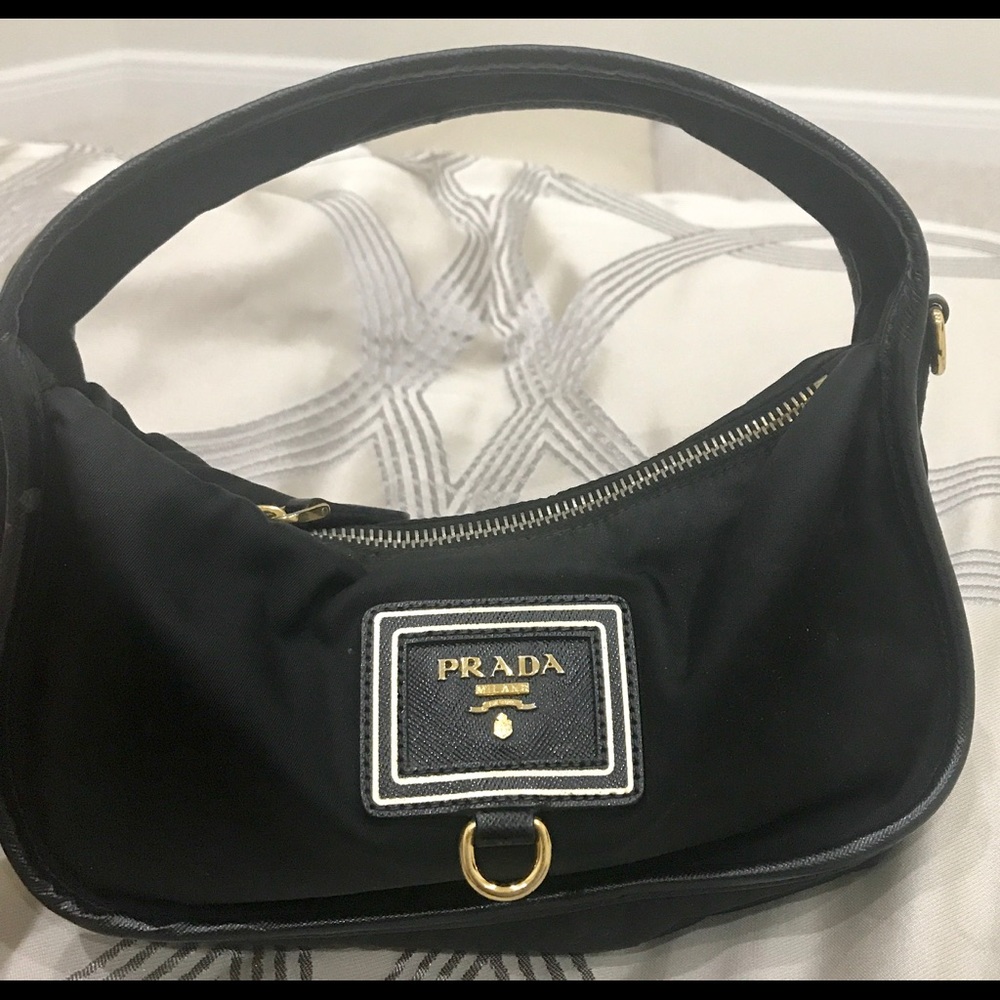 *Black with gold mini Prada*